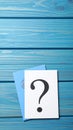 Paper cards with question mark on blue wooden background, top view. Space for text Royalty Free Stock Photo
