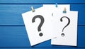 Paper cards with question mark on blue wooden background, top view. Space for text Royalty Free Stock Photo