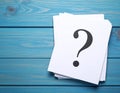 Paper cards with question mark on blue wooden background, top view. Space for text Royalty Free Stock Photo