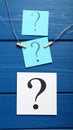 Paper cards with question mark on blue wooden background, top view. Space for text Royalty Free Stock Photo