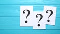 Paper cards with question mark on blue wooden background, top view. Space for text Royalty Free Stock Photo
