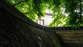 Japanese Garden Wall with Lush Greenery and Hidden Building Royalty Free Stock Photo