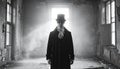 A person wearing a top hat, ornate mask, and long coat stands in an abandoned, deteriorating room. Royalty Free Stock Photo