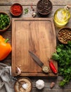 Cooking concept. Cutting board and different products on wooden table, flat lay Royalty Free Stock Photo