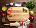 Cooking concept. Cutting board and different products on wooden table, flat lay Royalty Free Stock Photo