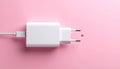 Pink background, USB power adapter and charging cable on flat panel. Royalty Free Stock Photo
