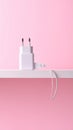 Pink background, USB power adapter and charging cable on flat panel. Royalty Free Stock Photo