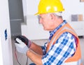 Electrician Testing Electrical Outlet with Multimeter Royalty Free Stock Photo