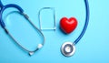 Stethoscope and heart model on color background, top view. Medical equipment Royalty Free Stock Photo