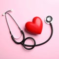 Stethoscope and heart model on color background, top view. Medical equipment Royalty Free Stock Photo