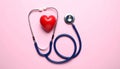 Stethoscope and heart model on color background, top view. Medical equipment Royalty Free Stock Photo