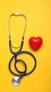 Stethoscope and heart model on color background, top view. Medical equipment Royalty Free Stock Photo