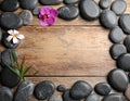 Frame made with spa stone on wooden table, top view. Space for text Royalty Free Stock Photo