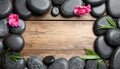 Frame made with spa stone on wooden table, top view. Space for text Royalty Free Stock Photo