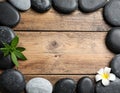 Frame made with spa stone on wooden table, top view. Space for text Royalty Free Stock Photo