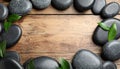 Frame made with spa stone on wooden table, top view. Space for text Royalty Free Stock Photo