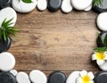 Frame made with spa stone on wooden table, top view. Space for text Royalty Free Stock Photo