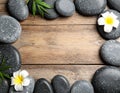 Frame made with spa stone on wooden table, top view. Space for text Royalty Free Stock Photo
