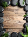 Frame made with spa stone on wooden table, top view. Space for text Royalty Free Stock Photo