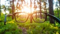 Glasses against the beautiful forest. View more clearly through the lenses. Royalty Free Stock Photo