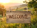 Welcome card. Wooden board with word hanging on rope in countryside Royalty Free Stock Photo