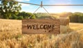 Welcome card. Wooden board with word hanging on rope in countryside Royalty Free Stock Photo