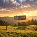 Welcome card. Wooden board with word hanging on rope in countryside Royalty Free Stock Photo