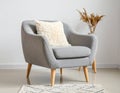 Soft armchair with pillow in light room Royalty Free Stock Photo