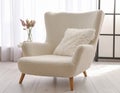 Soft armchair with pillow in light room Royalty Free Stock Photo