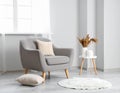 Soft armchair with pillow in light room Royalty Free Stock Photo