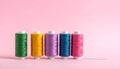 Meshes with colored sewing threads on a pink background, straight line Royalty Free Stock Photo
