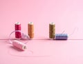 Meshes with colored sewing threads on a pink background, straight line Royalty Free Stock Photo