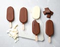 Delicious glazed ice cream bars and chocolate on light grey marble table Royalty Free Stock Photo