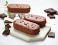 Delicious glazed ice cream bars and chocolate on light grey marble table Royalty Free Stock Photo