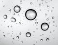 Rain drops on glass against grey background Royalty Free Stock Photo