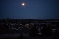 A view of the city at night with the moon in the sky. Canada. Royalty Free Stock Photo