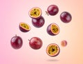 Fresh passion fruits spinning in the air against a color gradient background. Royalty Free Stock Photo