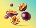 Fresh passion fruits spinning in the air against a color gradient background. Royalty Free Stock Photo