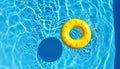 Inflatable ring floating in swimming pool on sunny day, top view with space for text Royalty Free Stock Photo