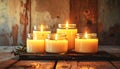 A collection of ritual candles glowing warmly in glass jars, placed on a rustic wooden surface Royalty Free Stock Photo