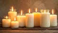 A collection of ritual candles glowing warmly in glass jars, placed on a rustic wooden surface Royalty Free Stock Photo