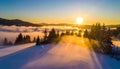 Warm cold winter sunset. Last rays of setting sun coloring the fog golden in this winter Royalty Free Stock Photo