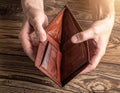 Empty open brown leather wallet held in hands, no money. Royalty Free Stock Photo
