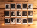 Collection of moon phase photos on rustic wooden table under warm light Royalty Free Stock Photo