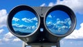 Binoculars with blue sky and clouds reflected in the lenses - future vision metaphor Royalty Free Stock Photo