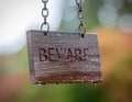 Wet Wooden Beware Sign Hanging on Chains Royalty Free Stock Photo