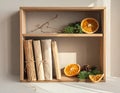 Rustic Shelf Display with Dried Oranges, Pine, and Wrapped Books Royalty Free Stock Photo