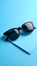 Stylish sunglasses on blue background. Fashionable accessory Royalty Free Stock Photo