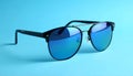 Stylish sunglasses on blue background. Fashionable accessory Royalty Free Stock Photo