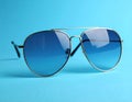 Stylish sunglasses on blue background. Fashionable accessory Royalty Free Stock Photo